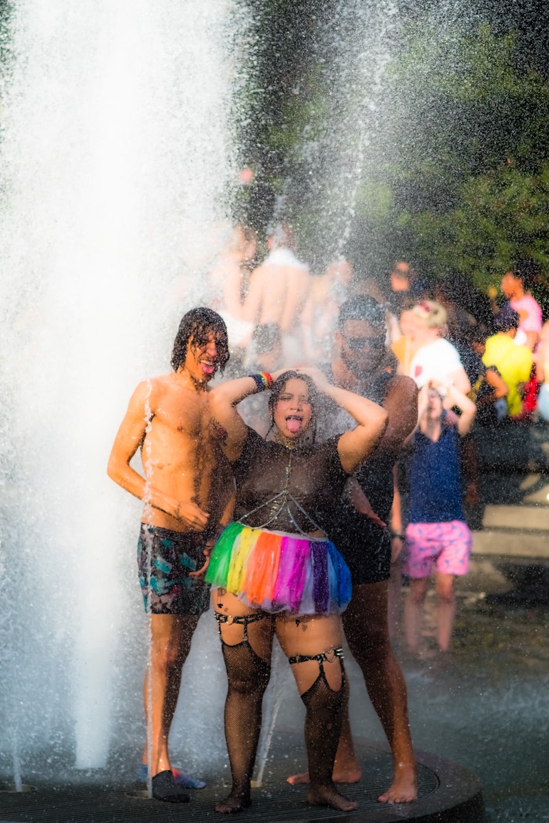 woman and man standing on water fountain